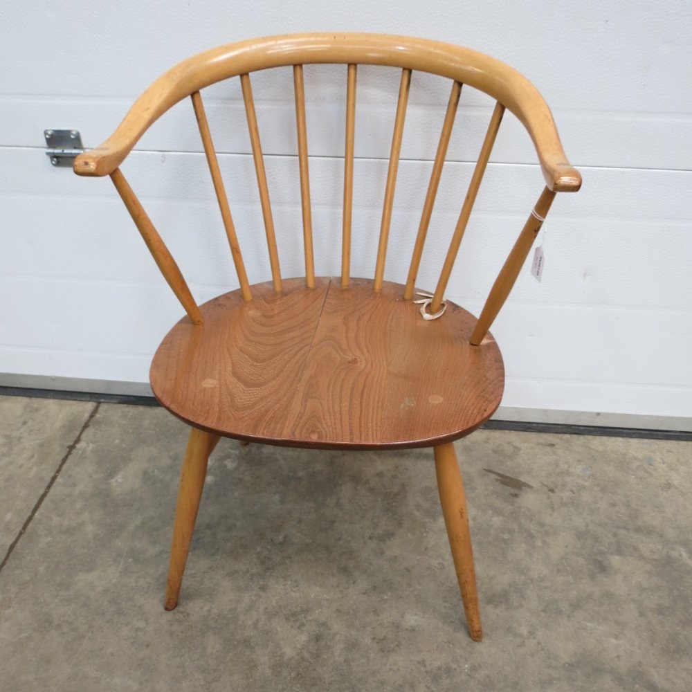 A single elm seated Ercol spindle back e: A single elm seated Ercol spindle back elbow chair, c1960's.