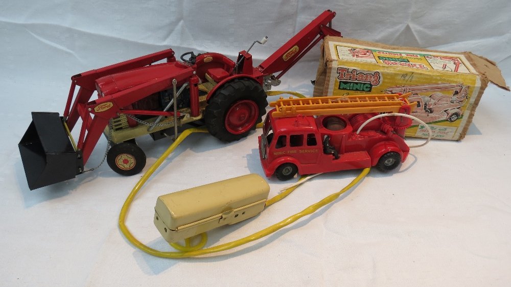 A 1960's Japanese tin plate remote contr: A 1960's Japanese tin plate remote control Ford tractor, red and cream with lithograph engine together with a Trian Mimic Series II fire engine.