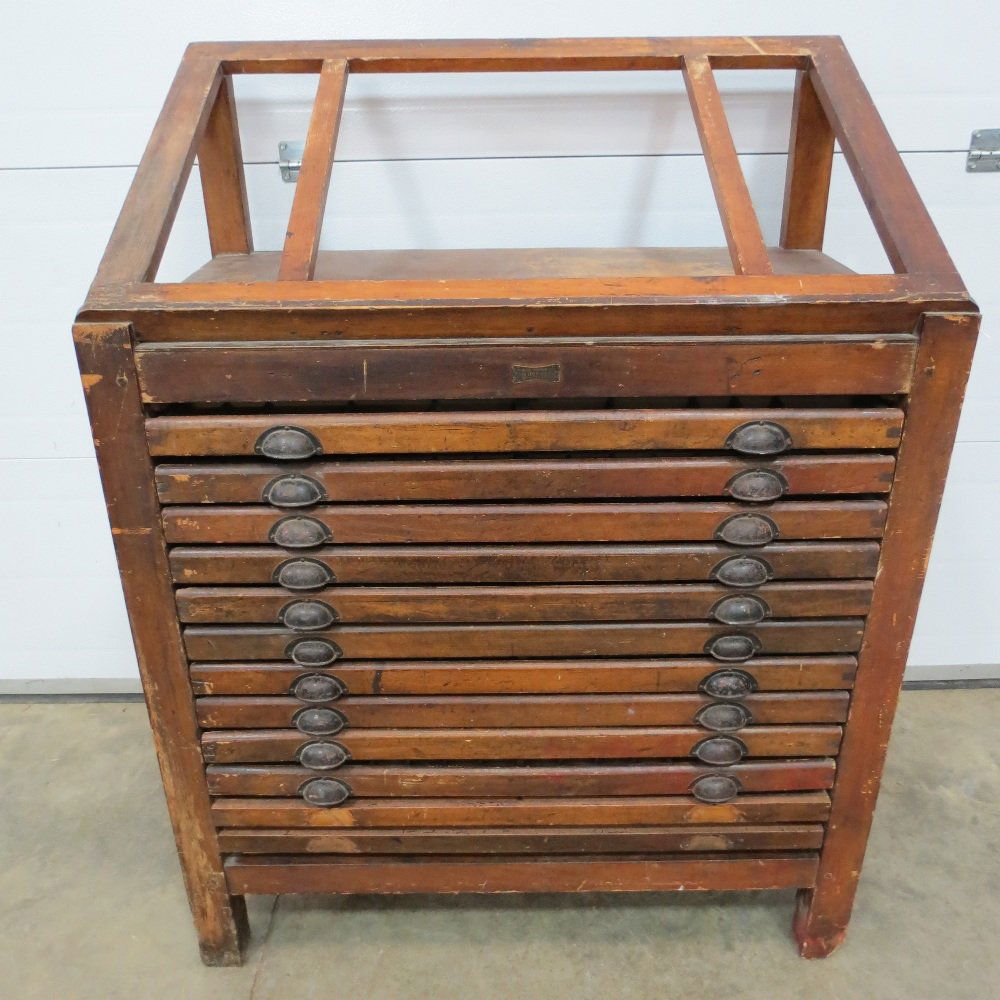 A printers cabinet, Belgian made, by Van Loey-Nouri of: A printers cabinet, Belgian made, by Van Loey-Nouri of Brussels, having twelve drawers each compartmentalised within, the top with 45 degree angle setting slope, all measuring 99cm wide.