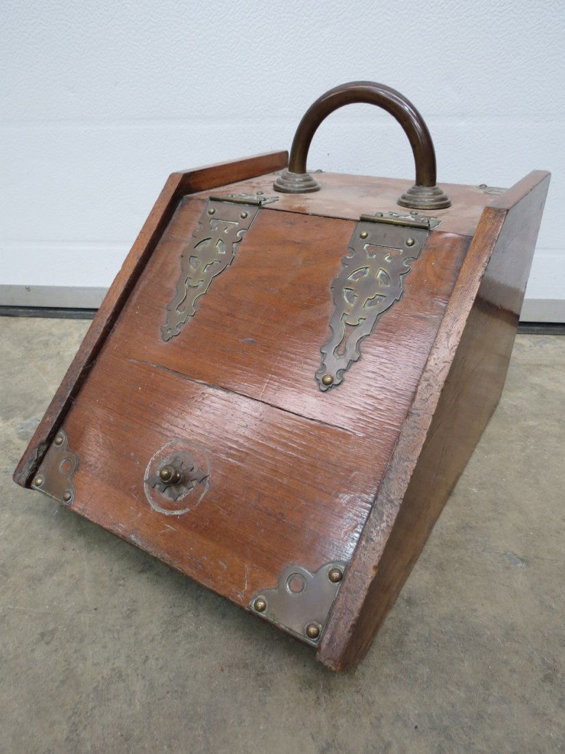 A late 19thC walnut and brass mounted coal scuttle with: A late 19thC walnut and brass mounted coal scuttle with a hoop handle and decorative hinges, the interior with a zinc liner, 47cm.