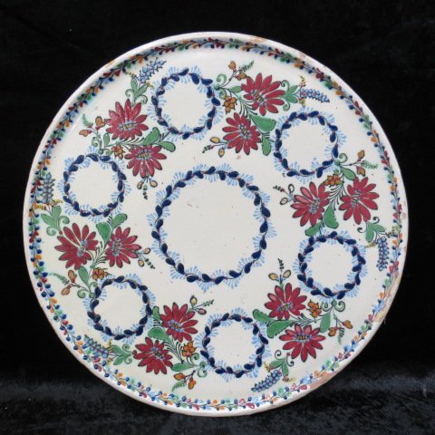 A Hungarian Judaic Passover Seder plate, of tri-glazed: A Hungarian Judaic Passover Seder plate, of tri-glazed earthenware hand decorated with fruit and flowers, 42cm.