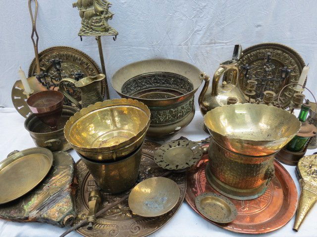 A quantity of copper and brassware including a 'Johnnie: A quantity of copper and brassware including a 'Johnnie Walker' advertising tray, pair of candlestick , two pairs of bellows and a jardiniere.