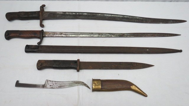 A 19thC Continental bayonet in Scotland, the blade: A 19thC Continental bayonet in Scotland, the blade stamped C. Schilling, with a mahogany grip, 51cm long, together with another with shaped blade, a short early 20thC bayonet and a Middle Eastern dagg