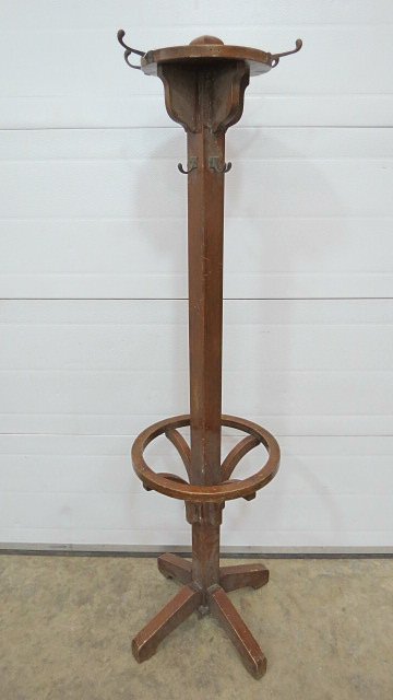 A 20thC mahogany hat and coat stand, with a central: A 20thC mahogany hat and coat stand, with a central square post with an array of hooks to the top and circular girdle a the mid point for umbrellas 180cm high.