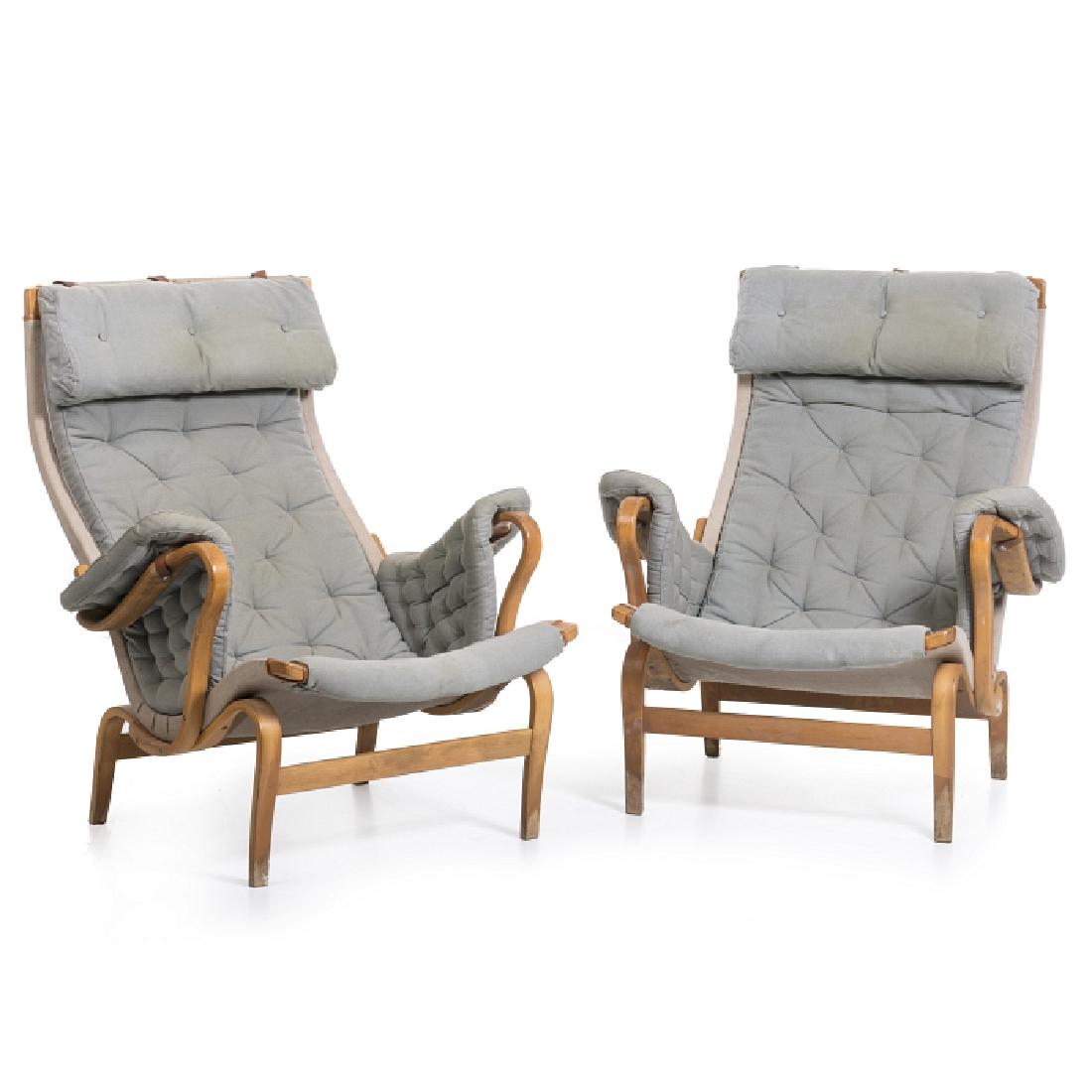 BRUNO MATHSSON (1907-1988) - Pair of Pernilla armchairs: Sweden, c. 1960, moulded beech, fabric upholstery, leather straps. Signs of wear. Dim.: 100x74x84 cm.