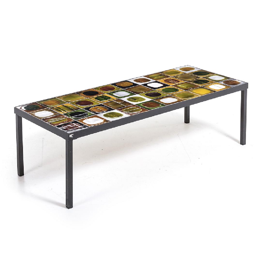 ROGER CAPRON (1922-2006) - Planete low table: France, c.1960, structure in iron patinated to black, top with glazed polychrome ceramic tiles. Dim .: 33x40,5x100,5cm.