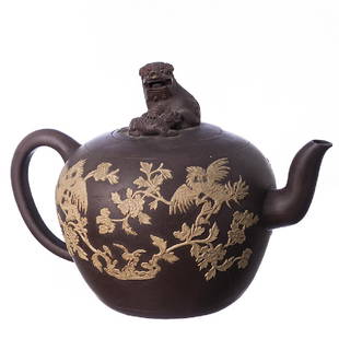 Large teapot in Chinese ceramics, Yixing: China, 20th century, Republic period, Yixing ceramics, relieved decoration with phoenixes amongst flowers, relieved pommel of the lid with kilins. Very slight faults, small defect in the lid. Dim.: 30