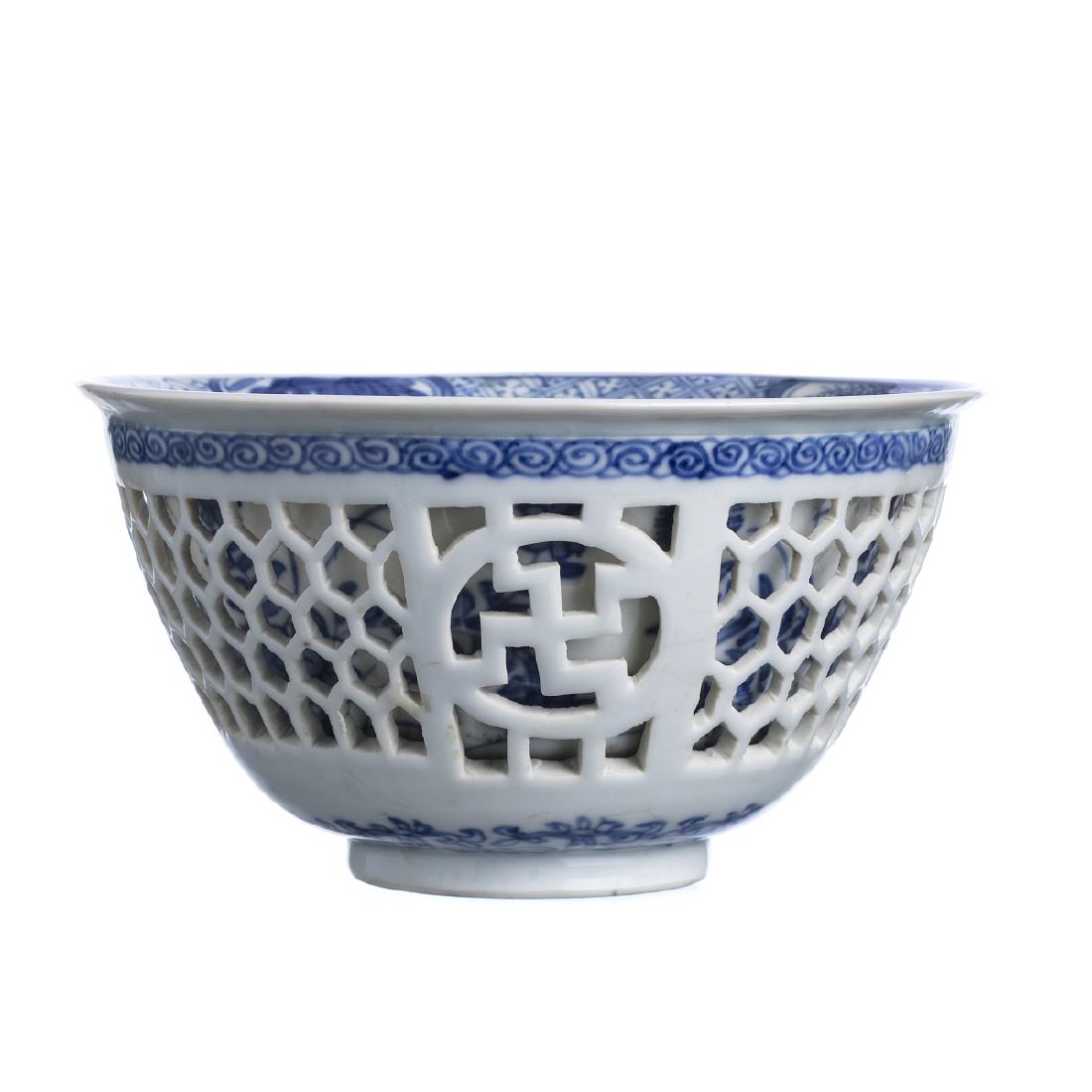 Chinese porcelain double walled bowl, Kangxi: China, Kangxi period, double-walled body with hexagonal openwork reserves, blue decoration of plant and floral motifs in blue and white. Mark on the bottom with flower. Small repair to rim, and minor 