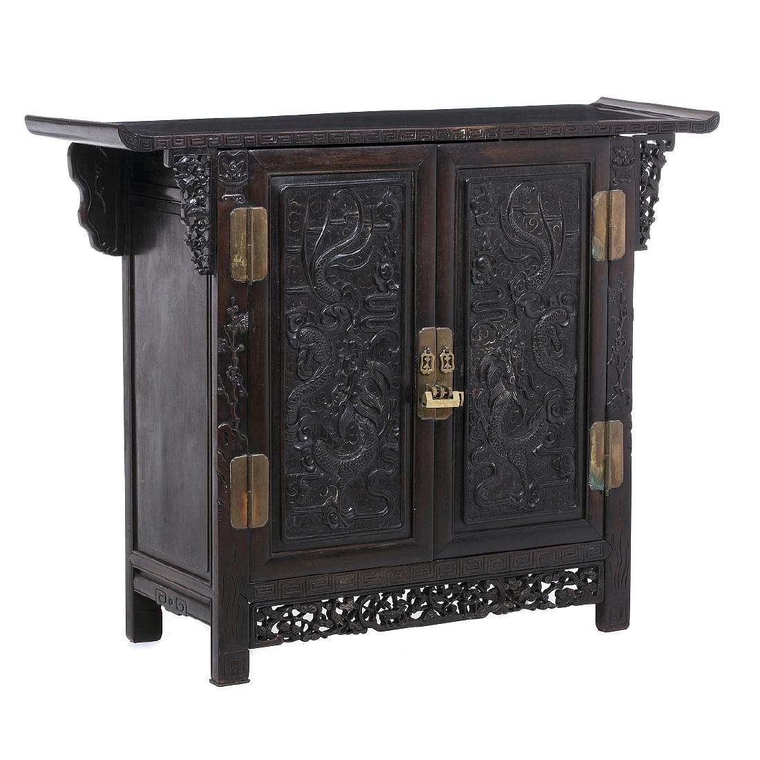 Chinese cabinet 'dragons' in hongmu. Minguo: China, 19th/20thC, carved hongmu, vegetable and dragon decoration, two-door, lock and metal hardware. Signs of use. Dim.:109.5x141x43,5cm.