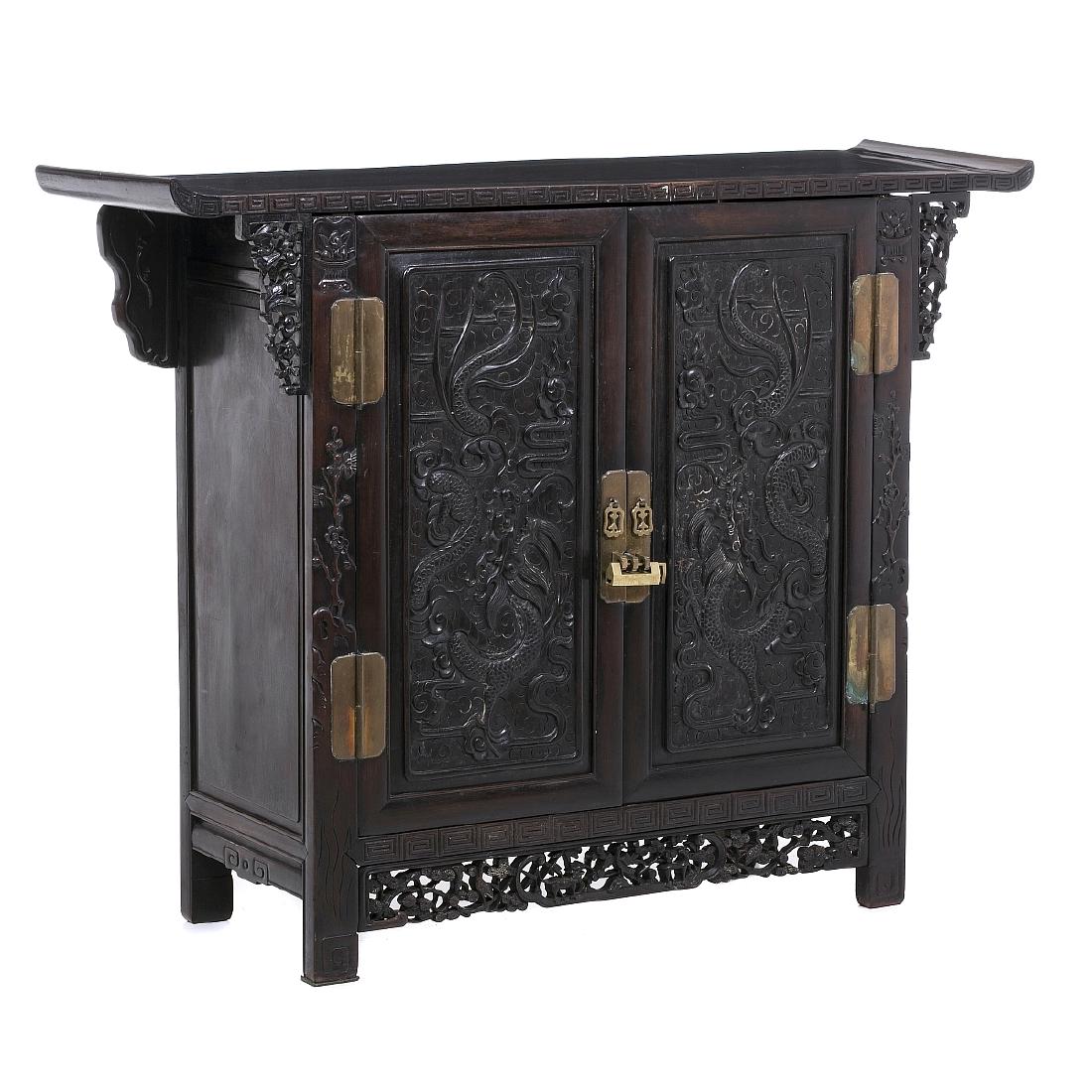 Chinese cabinet 'dragons' in hongmu. Minguo: China, 19th/20thC, carved hongmu, vegetable and dragon decoration, two-door, lock and metal hardware. Signs of use. Dim.:109.5x141x43,5cm.