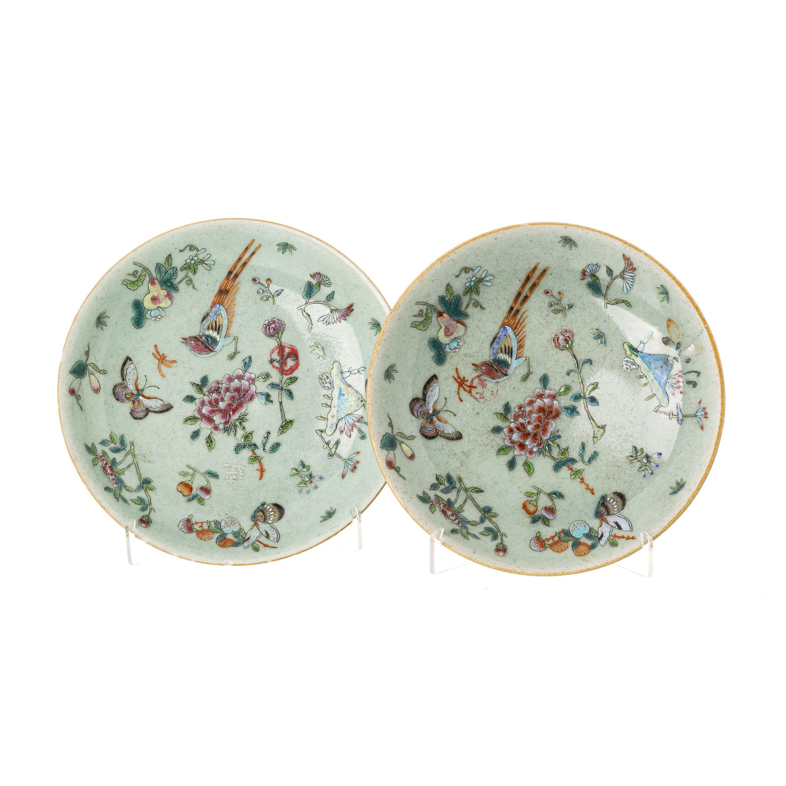 Pair of Chinese celadon ground plates, Tongzhi: China, Tongzhi, polychrome enamel and gold decoration, with flowers, birds, insects and butterflies on a celadon background. Mark on base. One with minimal flaws on the edge. Dim.:19.5cm.
