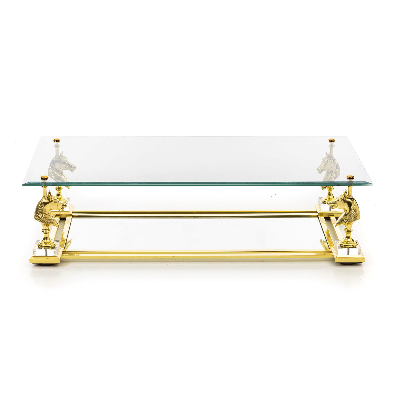 MAISON CHARLES - Cheval Coffee table: France, c.1970, structure in gilded brass, glass top, ornamentation with horse heads, top and tray on glass base. Signs of use. Dim.:36x140x70cm.