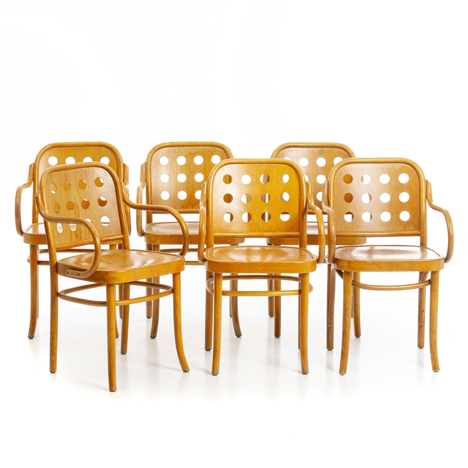 JOSEPH HOFFMANN - Set of six armchairs 6010: Poland, c.1960-70, thermoformed wood, backrest with perforated circles, model created by Josef Hoffmann and Oswald Haerdtl in 1929, manufactured by FMG. Label 'FMG/Made in Poland'. Signs of use, minor