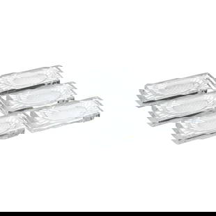 LALIQUE FRANCE - Six 'Thistle Blossom' knife rests: France, 20th century, moulded and incised crystal, decorated with thistle flowers. Marked 'Lalique, France'. Signs of use. Dimensions: 5.2x8.5x1.3cm (each).