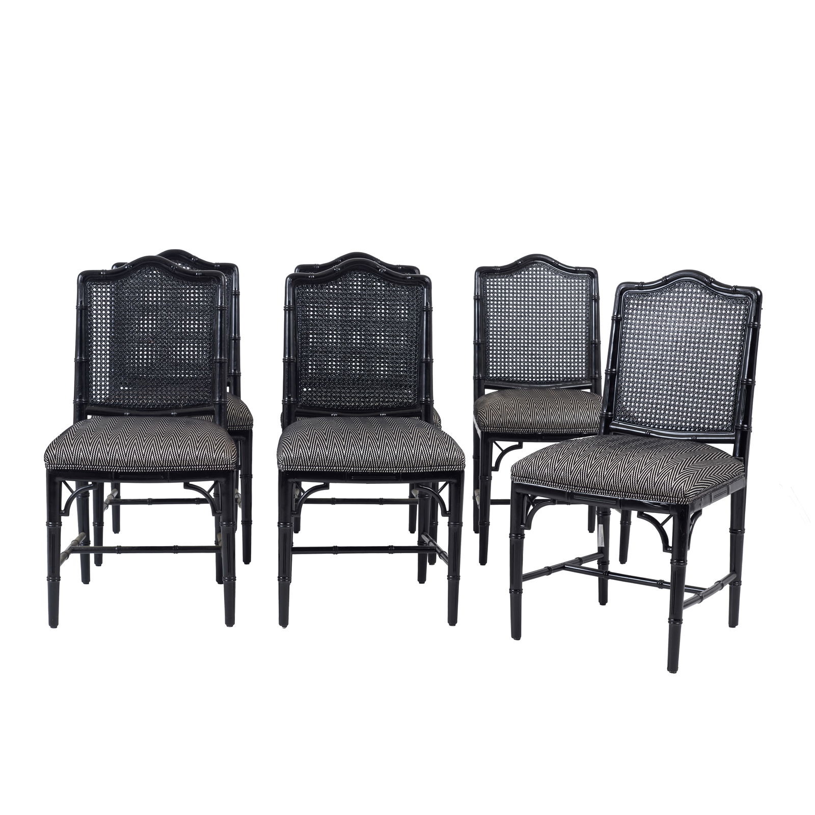 ENGLISH WORK c.1990 - Six 'faux bamboo' chairs: England, c.1990, carved and black-lacquered wood, 'faux bamboo' decoration, backrest and seat in black-painted rush, seat with added herringbone-patterned fabric upholstery. Flaws and defects. Dim.: 9