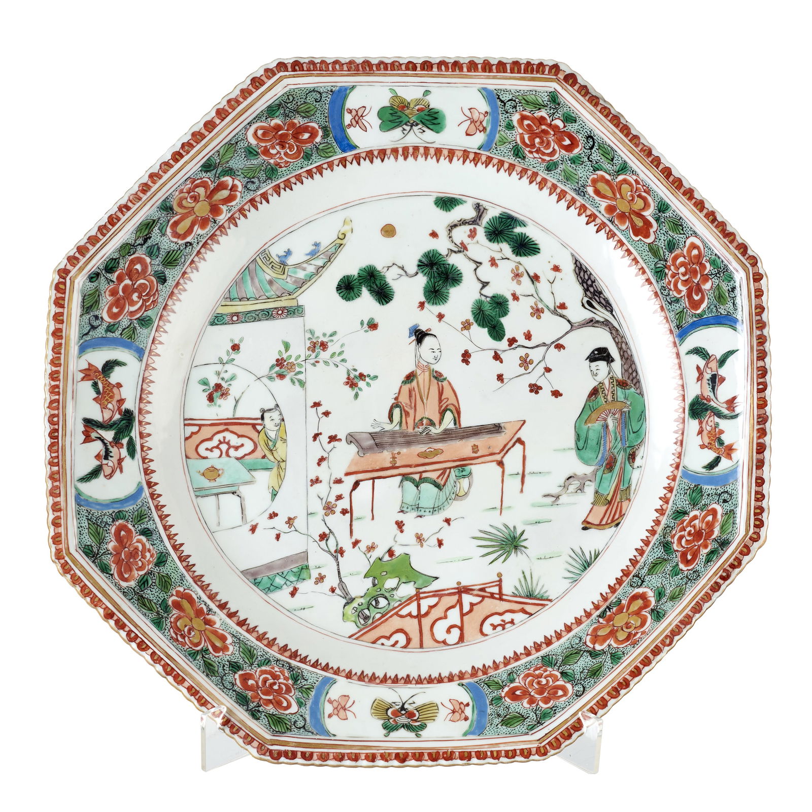 Large Chinese famille-verte porcelain plate, Kangxi: China, Kangxi, octogonal, porcelain, gilt and polychrome famille verte decoration, central reserve with figures in a daily life scene, rim with floral motifs and reserves with fish and insects. Signs