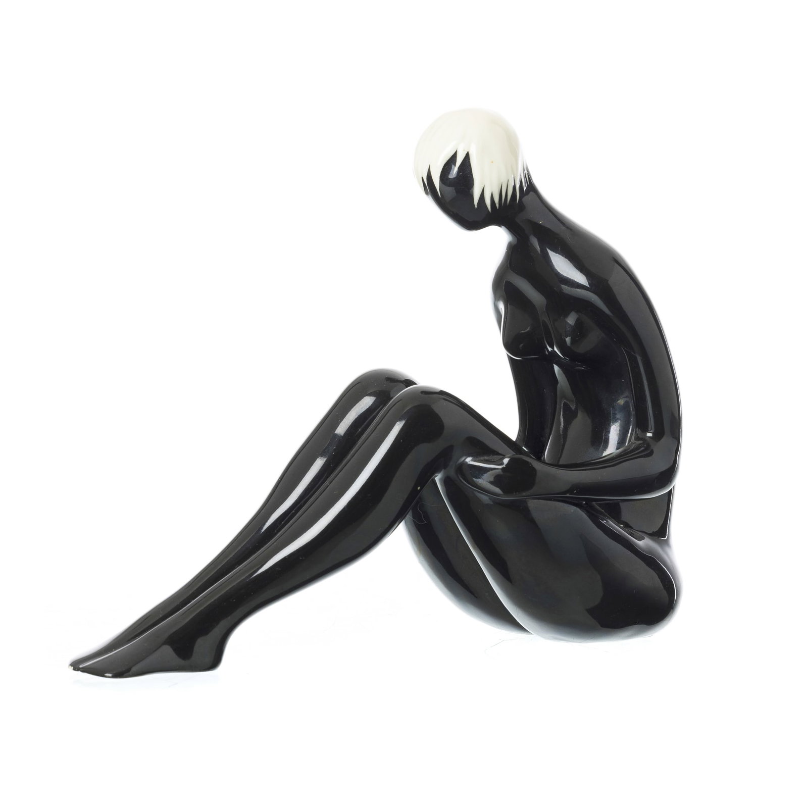 ARAUJO SOARES (1927-2007 - Seated female nude: Ceramics from Viana do Castelo, c.1950, molded, glazed and polychrome decoration in black and white. Marked 'C.F Viana' on the base. Signs of use. Dim.: 27cm.