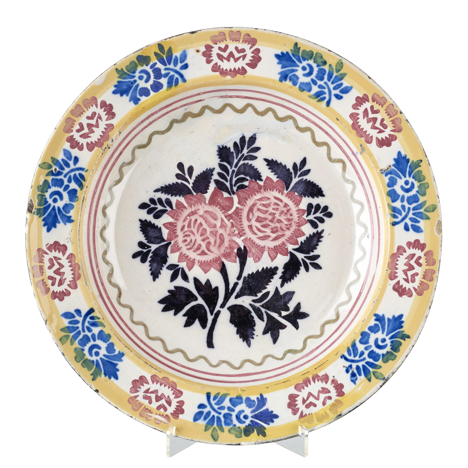 Portuguese earthenware plate: Portuguese earthenware, 19th century, polychrome glazed decoration with floral motifs. Minor flaws. Dim.: 35cm.