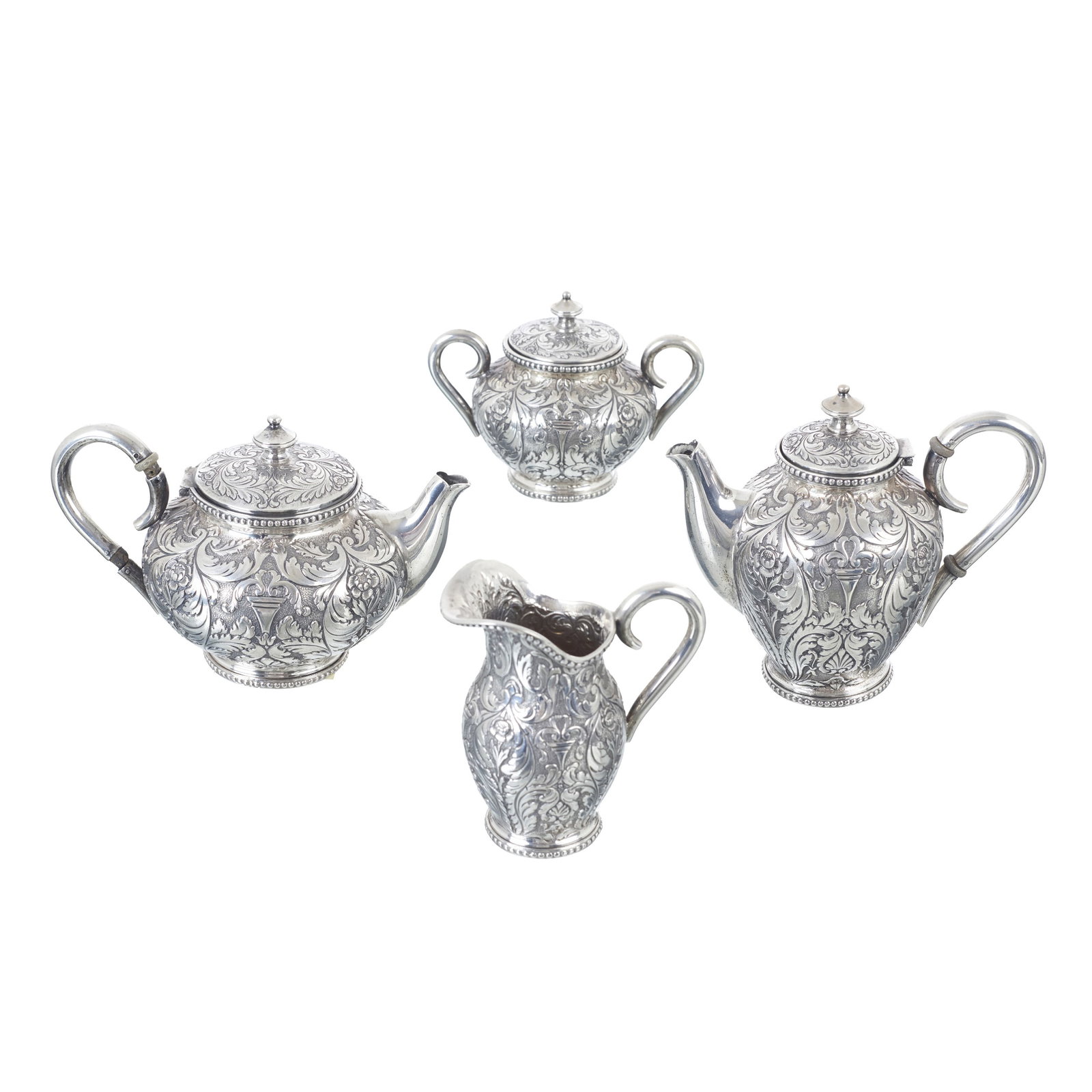 TOPaZIO - Silver service: Portuguese silver, 833 eagle hallmark (1938-1984), silversmith?s mark of Ferreira Marques & Irmao (reg. 1934); raised and chiselled decoration featuring plant and floral motifs; beaded edges. Signs