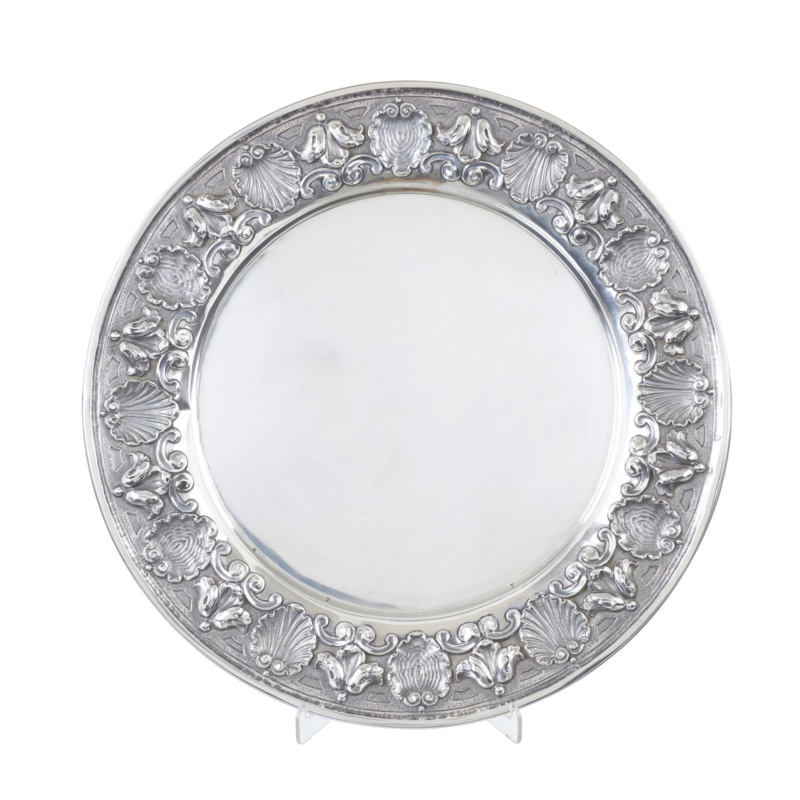 Chased border Silver charger: Portuguese silver, 833 eagle hallmark (1938-1984), silversmith?s mark of Eduardo Martins Carneiro (1923-1959); raised decoration of flowers and scrolls, background engraved with volutes. Signs of