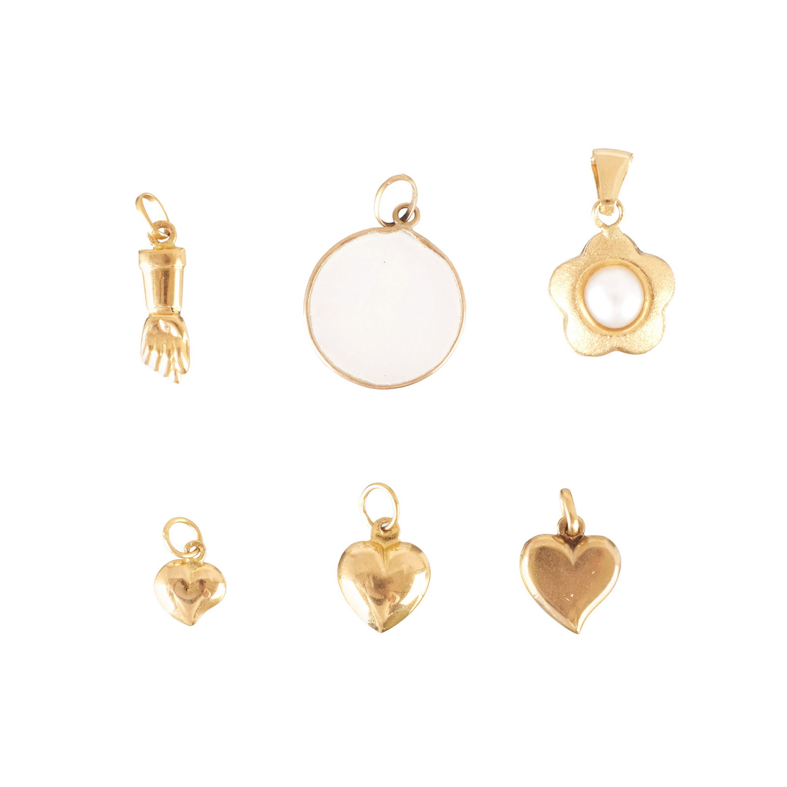 Six gold pendants: 800 yellow gold, deer hallmark, three heart-shaped charms, one flower-shaped charm with a pearl setting, one circular charm with mother-of-pearl, and one figa-shaped charm. Signs of wear. Approx.