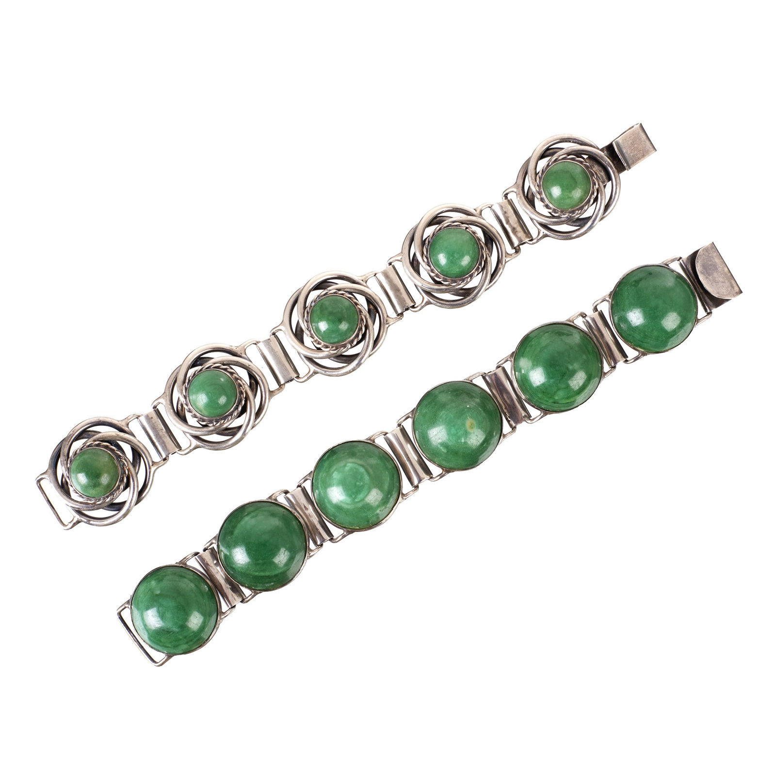 Two silver and jade Mexican bracelets: Mexico, c. 1960, 925 Mexican silver with oval cabochon nephrite jade. Marked. Signs of use. Approx. Total weight: 162g. Dim.: 18.5cm.