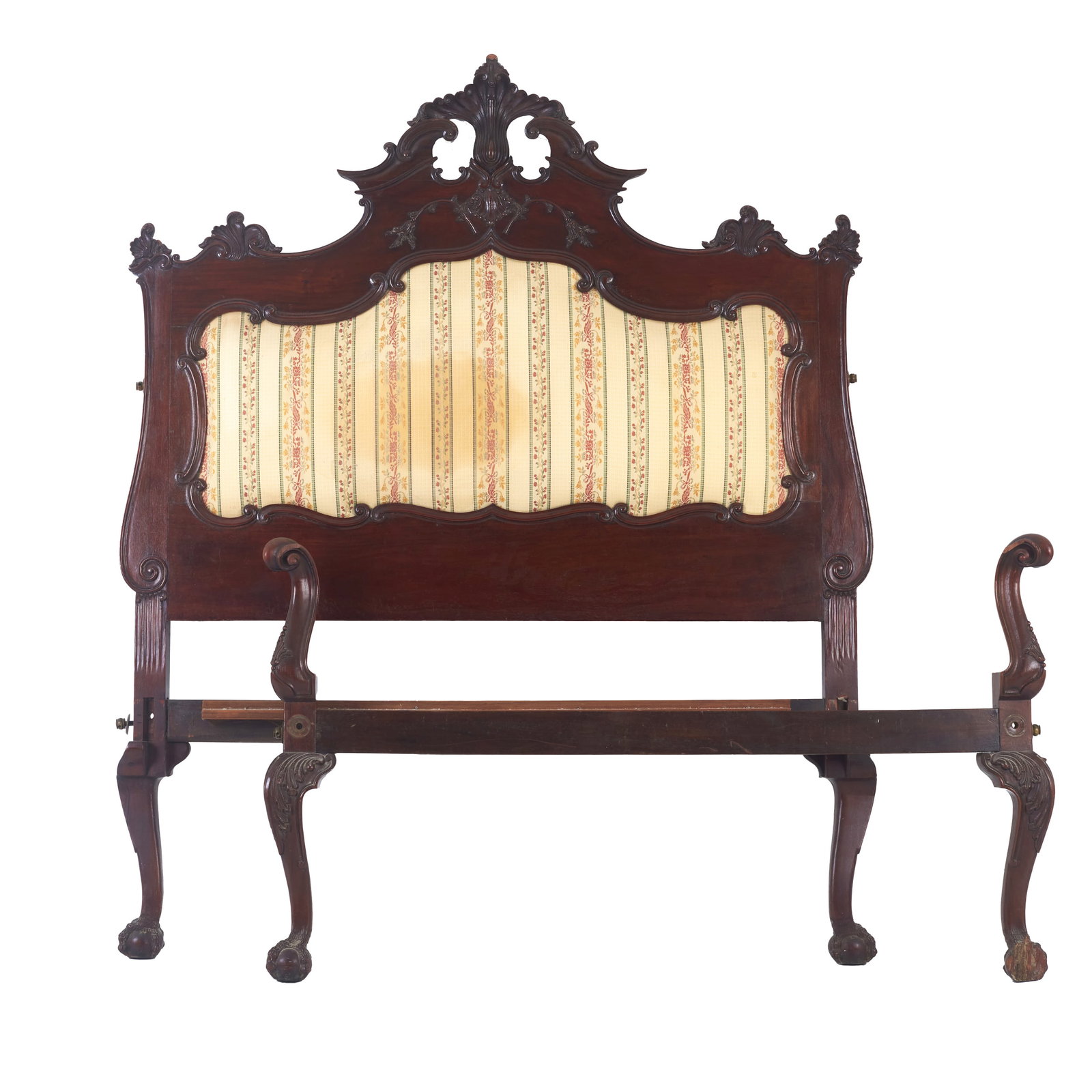 D. Jose bed: Portugal, 18th century, carved rosewood, openwork and carved headboard with a frieze featuring scrollwork, floral motifs and volutes; central medallion upholstered; bowed legs with claw-and-ball