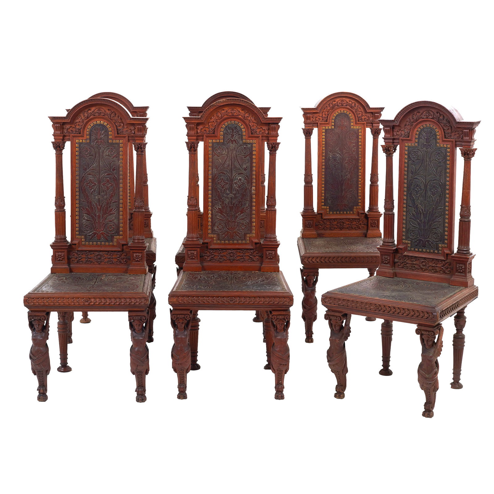 Six Chairs carved with Caryatids: FRance, 19th century, carved oak; seat and high backrest in embossed leather, framed by turned Corinthian columns; decorated with floral and plant motifs; gilded metal fittings; claw feet. Signs of