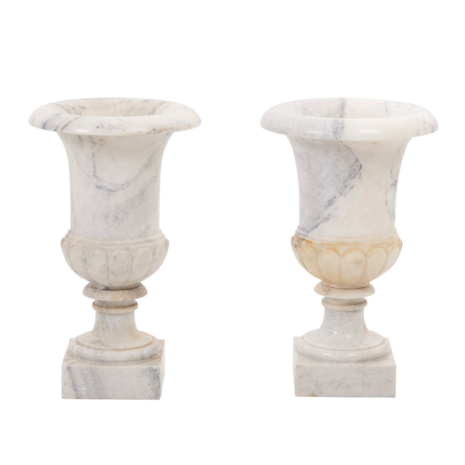 Pair of Medici-style marble vases: Italy, 19th/20th century, white marble, plain body with a rounded bulge; circular pedestal and rectangular plinth. Signs of use. Dim.: 68cm.
