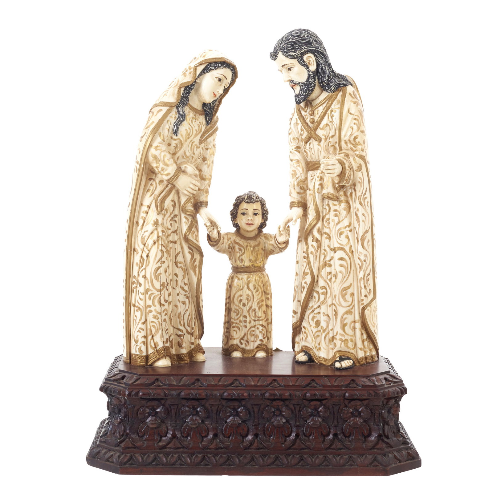 The Holy Family in Ivory: Spain, 20th century, sculptural group in ivory partially polychromed and gilded; base in carved wood with floral motifs. Signs of use. Dim. (total): 50cm.