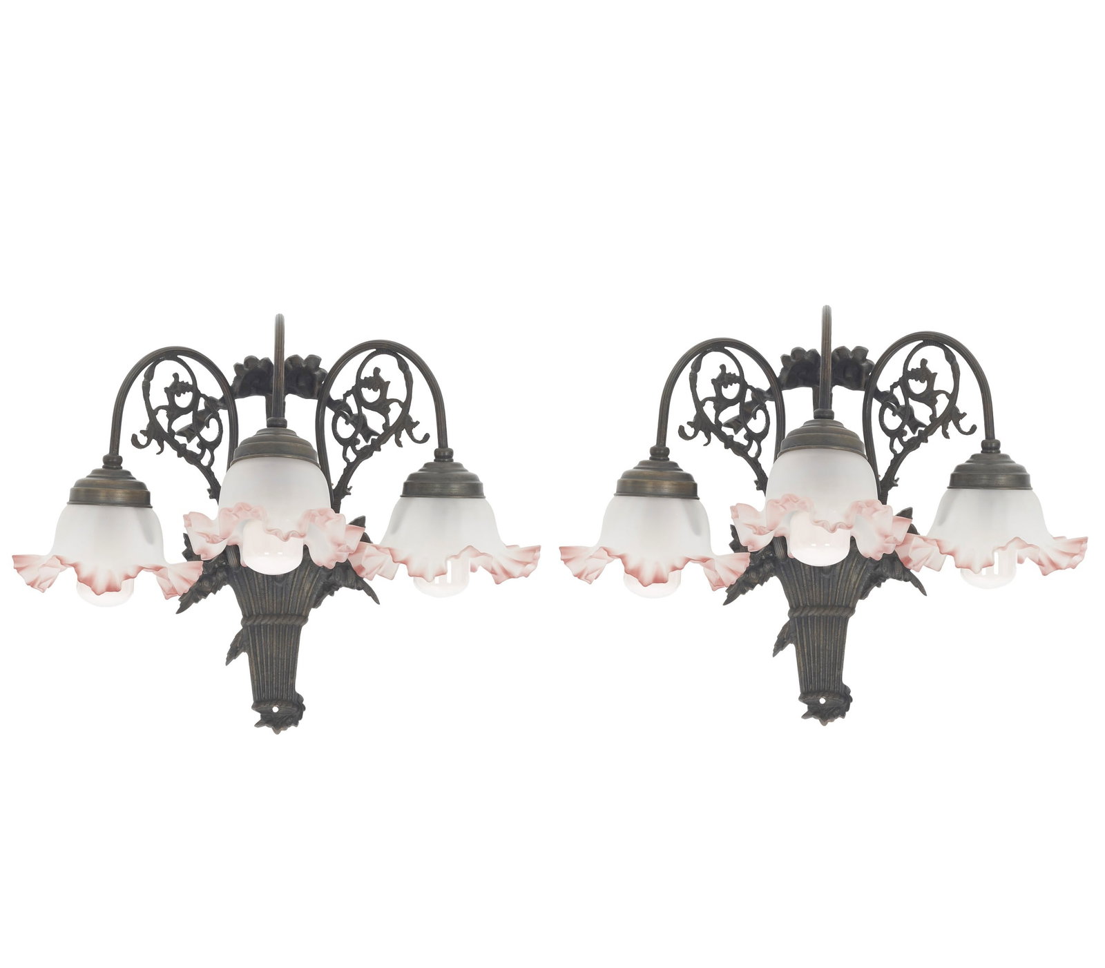 Pair of Art Nouveau style wall lights: France, 20th century, in patinated metal; twisted arms with scrolls and arabesques; a three-light lamp with frosted and pink glass shades. Fitted with light bulbs. Signs of use. Dim.: 34cm.