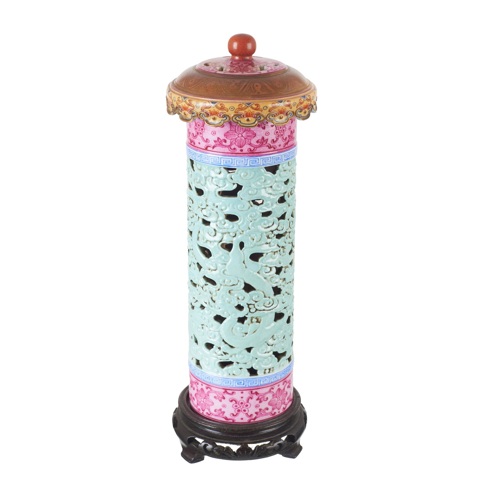 Chinese porcelain incense burner, Republic: China, Republic; hollow, raised cylindrical body, with polychrome enamel decoration in the pink family. Openwork wooden base. Signs of use. Dim.: 27.5 cm.