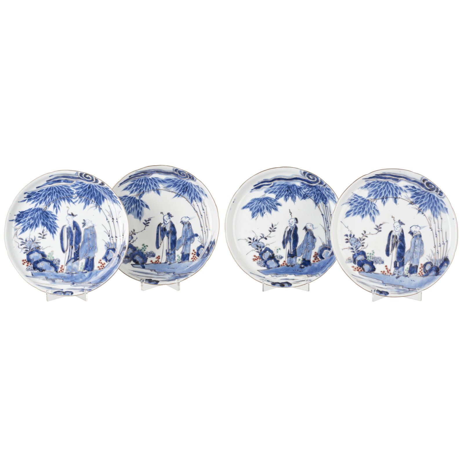 Four Arita porcelain plates: Japan, Meiji, polychrome and gilded decoration, depicting figures in landscape. Signs of use. Dim.: 21cm.
