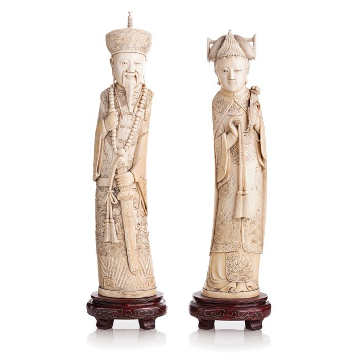Pair of Chinese emperors in ivory: China 20th Century, Minguo, ivory carvings representing Emperors couple with attributes, wooden base. Dim.: 29.5 cm total: 32.5 cm.