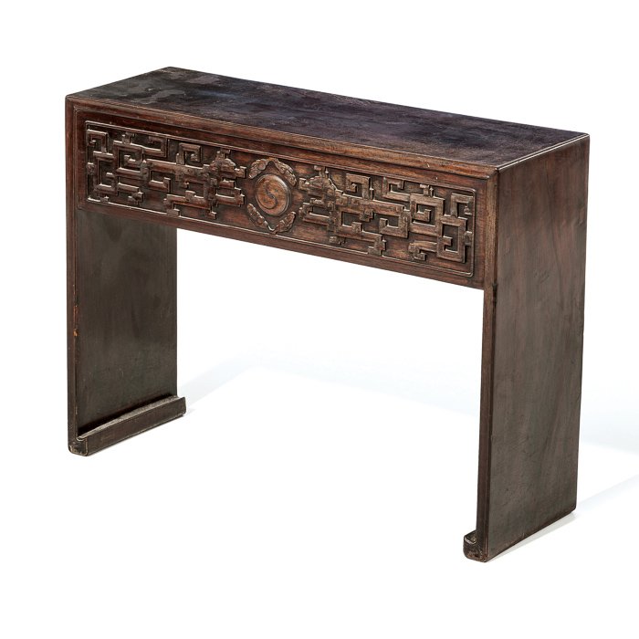 Carved altar table in tamarind: China, 19th century, tamarind wood, carved geometrical decoration in the Zitan style. Signs of wear. Dim.: 57.5x25x75 cm.