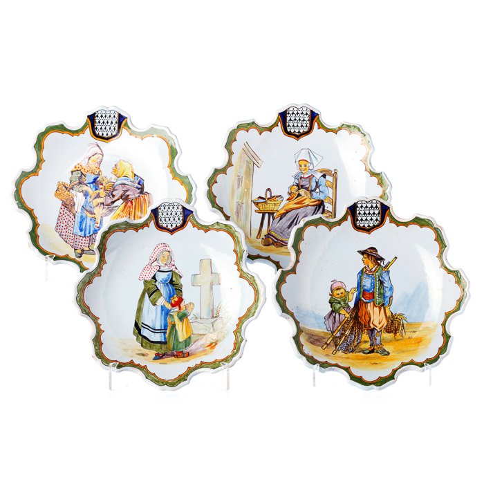 Four lobed saucers in French faience: Four lobed saucers in French faience France, 19th/20th century, possibly by Desvres, polychrome glazed decoration with daily scenes, lobed rim, with inscriptions on the back. Signs of wear. Dim.: 21.5