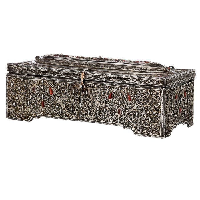 Ottoman calligraphy box: Ottoman Empire, 18th/19th century, wood coated with silver filigree and coral applications, inside: inkwell and sand box in silver. Signs of wear. Dim.:10x28x11cm.