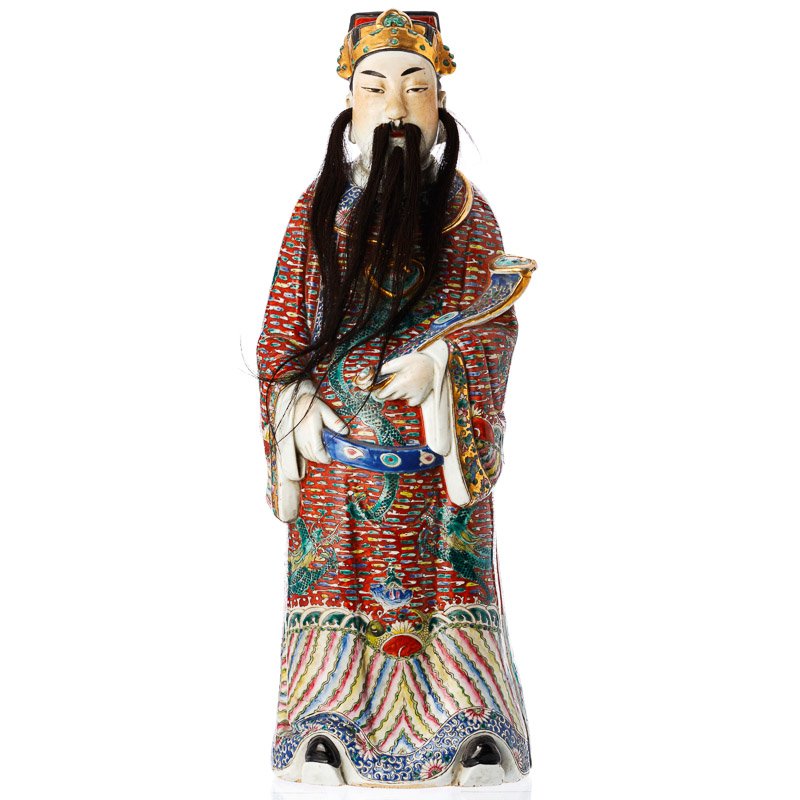 Immortal with scepter in Chinese porcelain: China, moulded porcelain, polychrome and gold decoration, figure with vests of dragons among clouds, holding a scepter in one hand, beard and hair in horse mane. Marks on the bottom. Dim.:61cm.