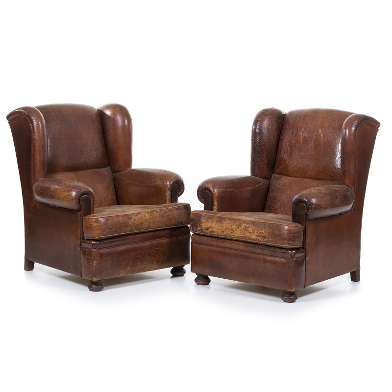 Pair of 'club' sofas: Portuguese, c.1950-60, in brown leather, ears sofa. Signs of wear, defects. Dim.:95x83x80cm.