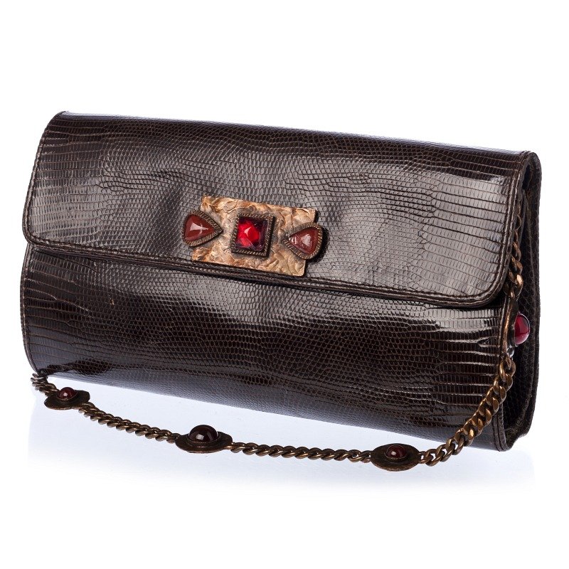 YVES SAINT LAURENT - Clutch in lizzard skin: Clutch bag in lizzard skin, brown, applications in hammered copper and coloured glass stones. Signs of wear, small defects. Marked. Dim.:14,5x27,5cm.
