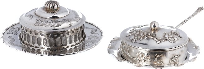 Pair of butter trays in Chinese silver: Silver with a Canton assay mark from the second aurter of the 19th century, with a relieved and cast decoration with a dragon; and another from Hong Kong from the first quarter of the 20th century, wi