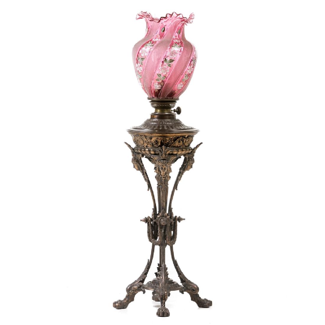 Romantic lamp oil: Oild candle in gilded bronze, a relieved decoration with plant motifs, a gargoyle, claw-shaped feet; a glass chimney, tulip in pink glass rosa with a decoration with polychrome and gold enamels. Signs