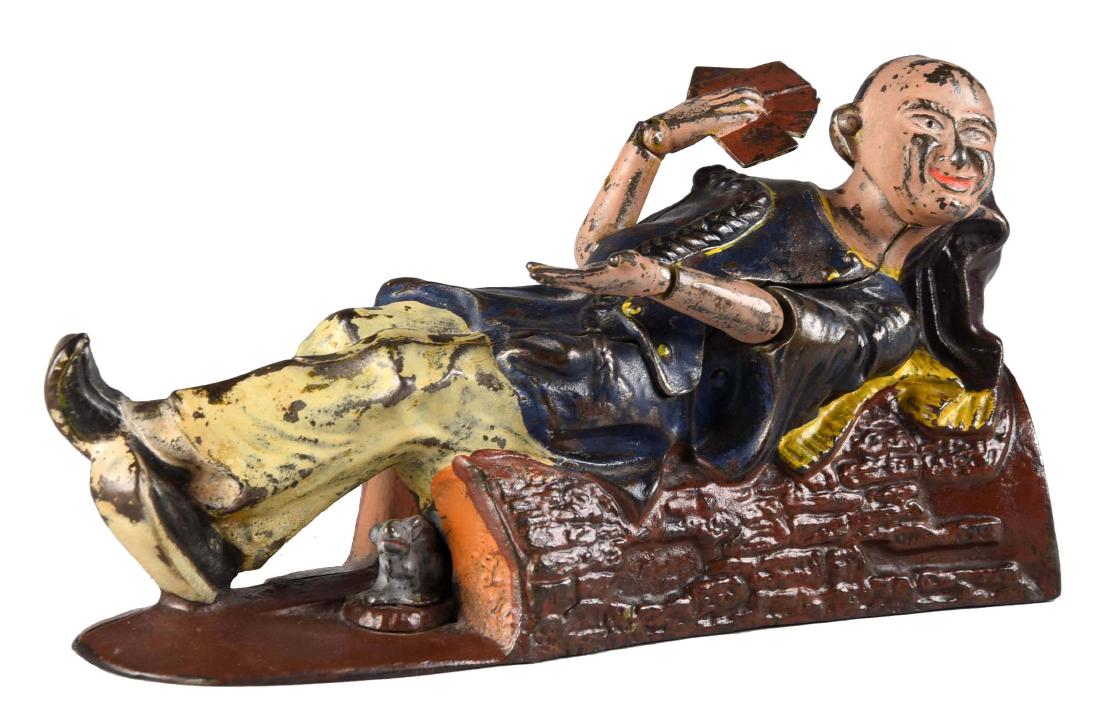 J. & E. Stevens Cast Iron Reclining Chinaman Mechanical: Place a coin in the slot and press lever. The Chinaman will show his hand of four aces and salute the depositor. As the coin falls into the bank, a rat runs out at the end of the log. Hands and arms a