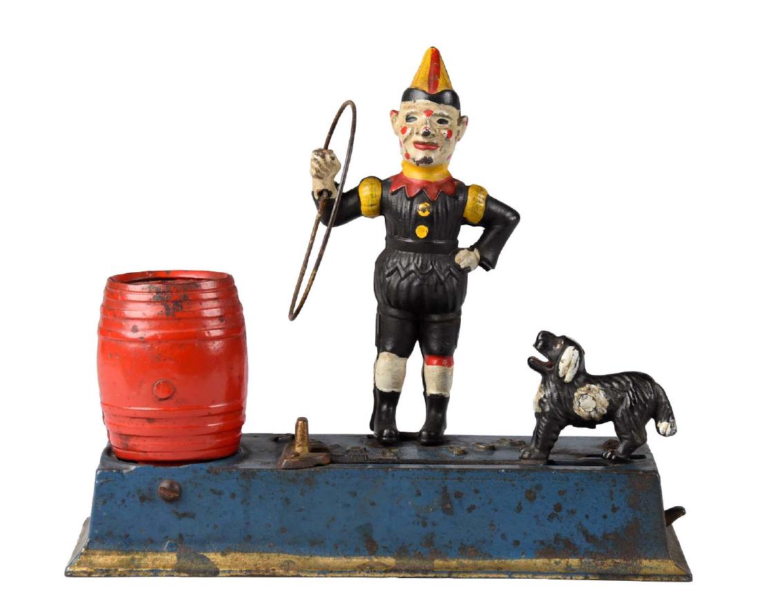 Jubley Cast Iron 1933 Trick Dog Mechanical Bank.: Place coin in the dog's mouth. Press the lever and dog jumps through the hoop to deposit the coin into the barrel. Bolt holding figure in place is replaced. Original trap. (JY). (Excellent). 8 -1/2" x