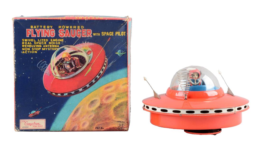 Japanese Tin Litho Battery-Operated Flying Saucer With: Made by KO Japan. When in operation travels with mystery actions, pilot moves arms back and forth. Nice colorful original box marked "Cragstan" who distributed the toy. Some edge wear and creasing to 
