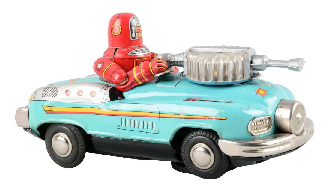 Japanese Tin Litho Battery Operated Robby Driving: Made by Nomura. When in operation toy travels with mystery action and Robby moves gun turret back and forth. Some minor scratching throughout. Nice lithography and coloring. (Very Good - Excellent). 8