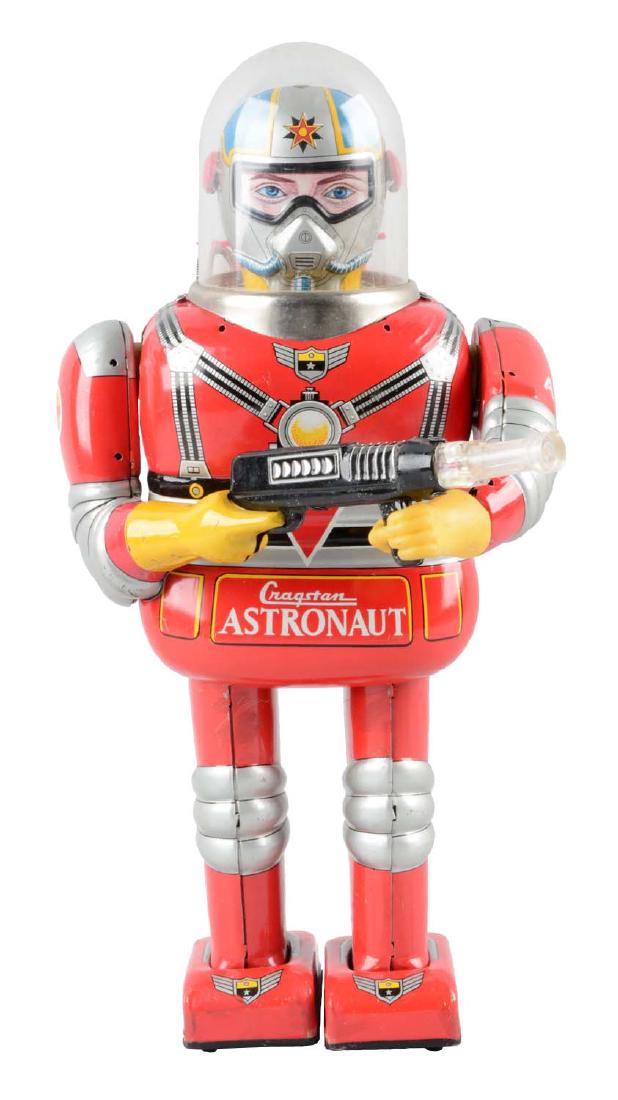 Japanese Tin Litho Battery Operated Cragstan Astronaut.: When in operation robot walks forward, stops, raises gun, gun lights and makes sound. Red litho version with astronaut face. Original dome. Marked "A-620" on the back battery pack. General scratching 