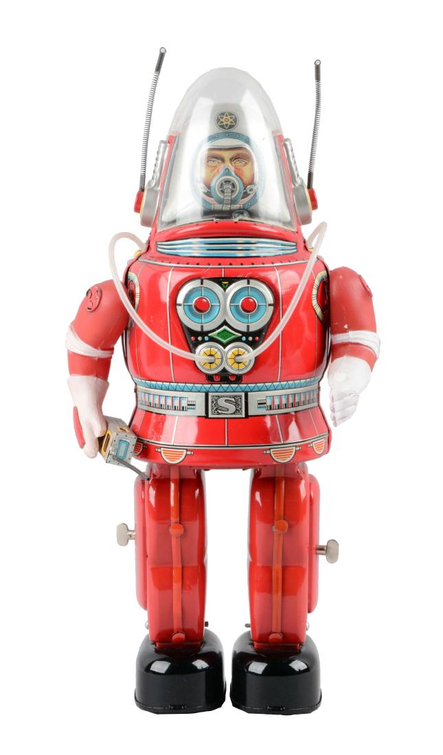 Japanese Tin Litho Battery Operated Rosco Astronaut.: Original vintage red version. When in operation, astronaut walks, lifts arms and talks into a walkie-talkie. Walkie-talkie illuminates. Right arm does not raise fully. Arms are vinyl. Robot is tin lit