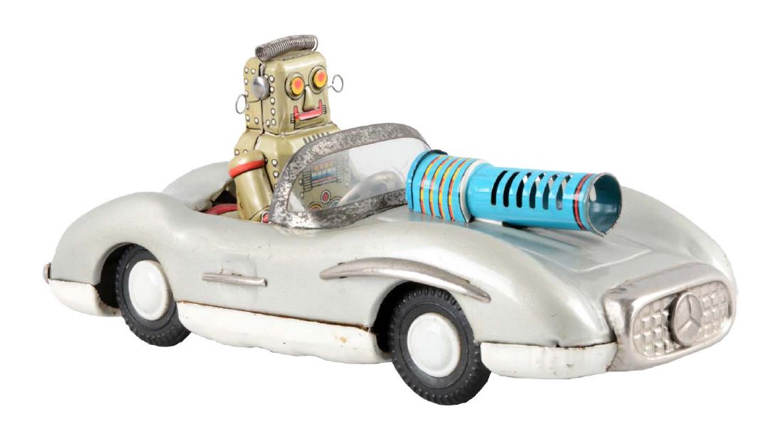 Japanese Tin Litho Friction Robot Driving Mercedes.: All original including gun in front. Some oxidation to bare metal parts. Minor scratching and wear. Mercedes emblem on front grill. (Very Good - Excellent). 8" L