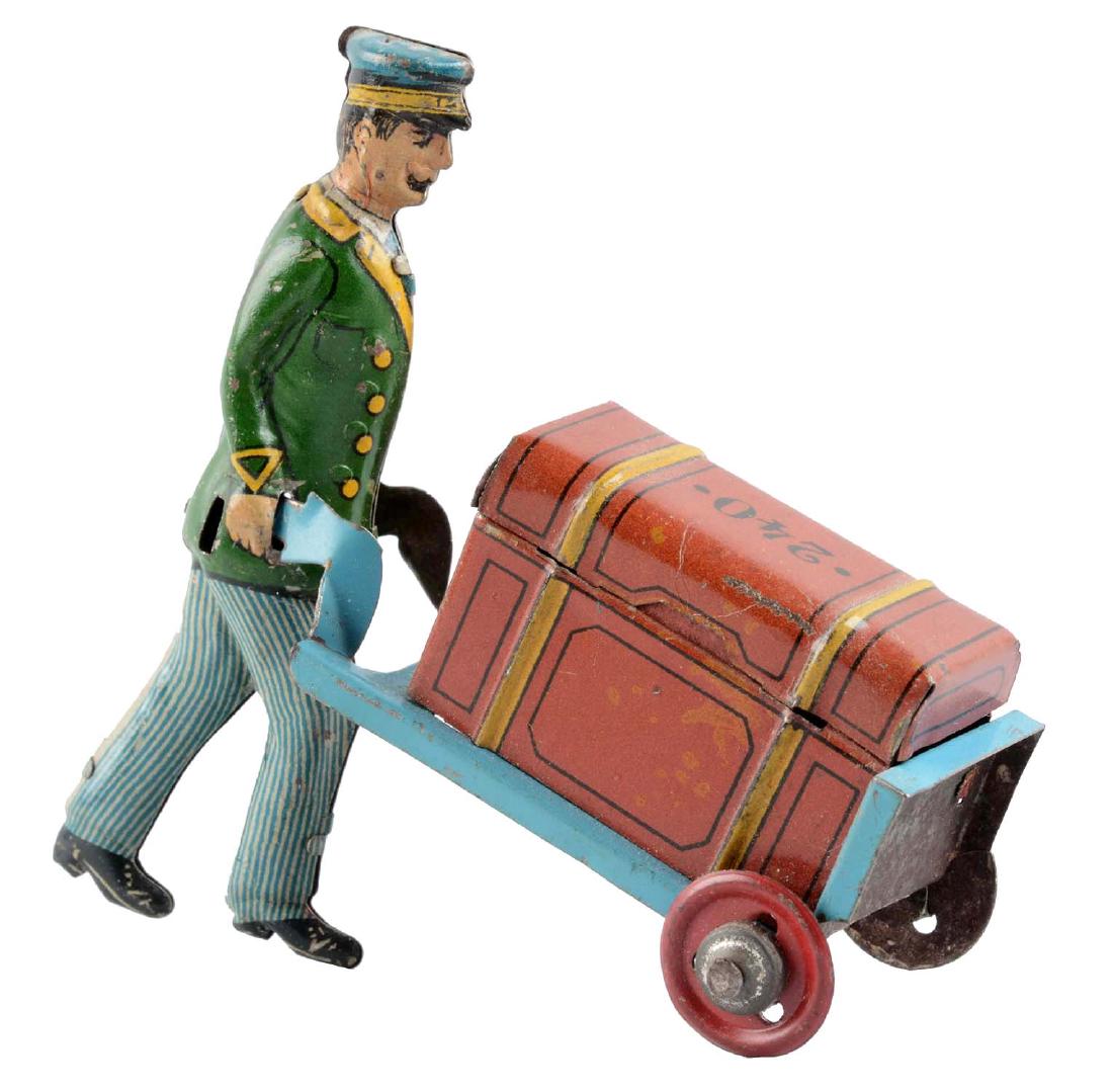German Tin Litho Porter Pushing a Trunk Penny Toy. (1 of 2)